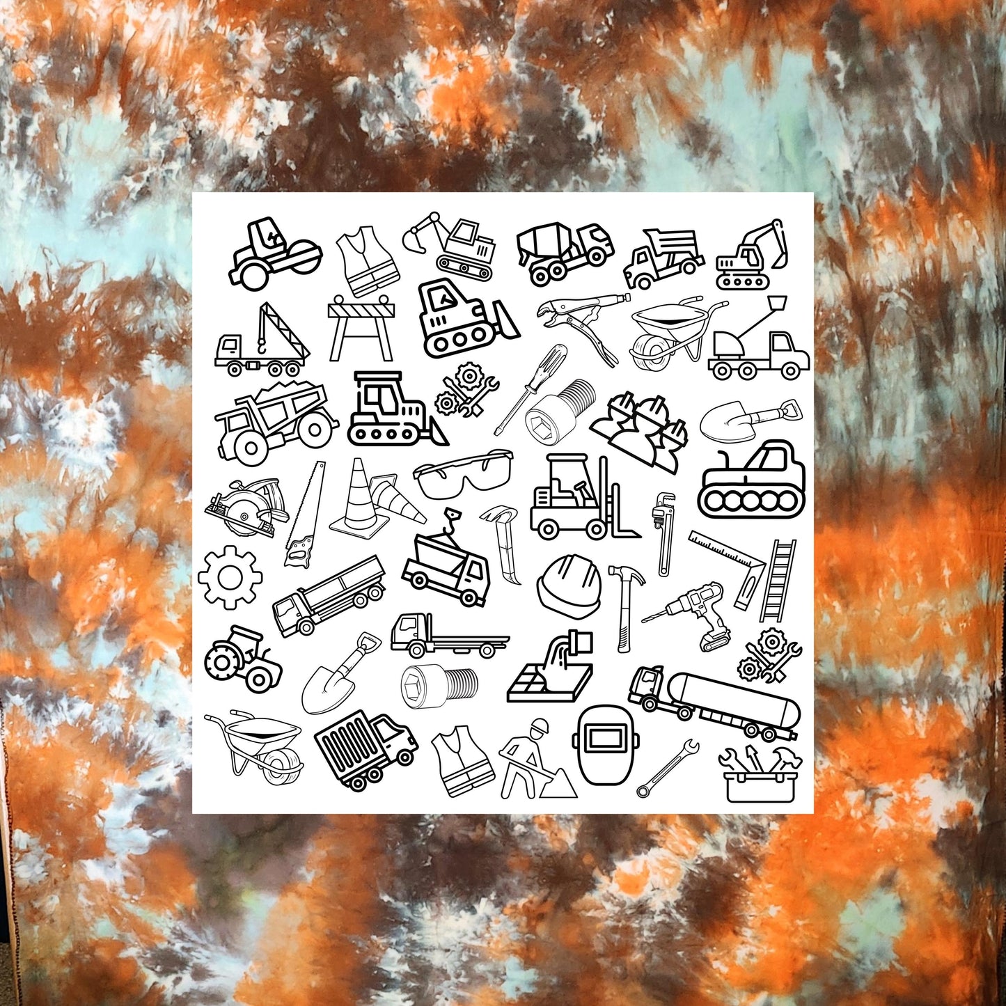 Construction Coloring panel placed on earth tone hand dyed fabric for inspiration. This fabric panel is a grouping of construction related object outlines ready to be colored if desired. It includes things from safety glasses to road equipment.  You can see the tools of the trade like saws, wrenches, gears, ladder, safety vest and hard hat. Then there is the heavy equipment like a forklift, dump truck, paver, crane, bucket truck, semi truck and more.