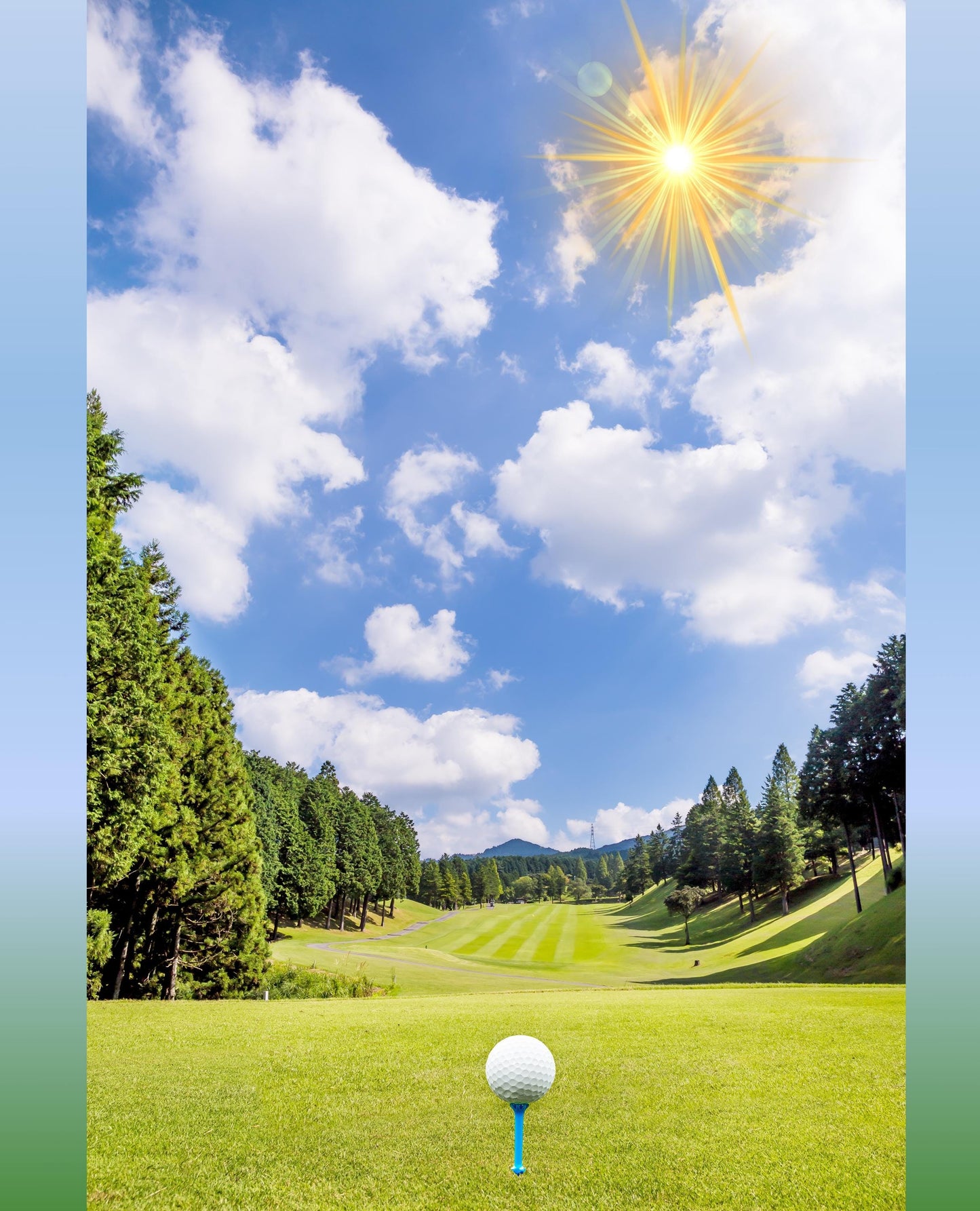 May include: A white golf ball on a blue tee on a green golf course. The golf course is surrounded by trees and the sky is blue with white clouds and a bright sun.